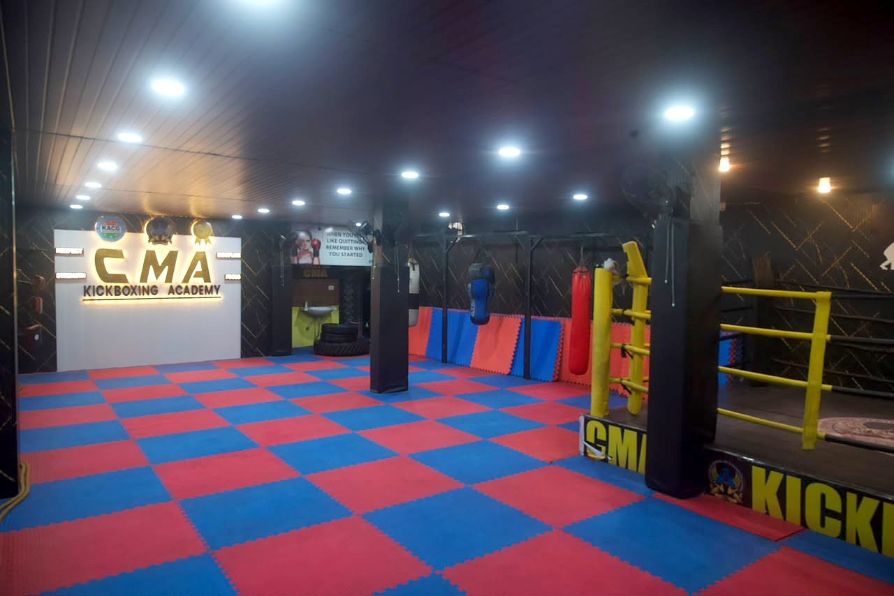 CMA Kickboxing Academy training hall with ring and mats
