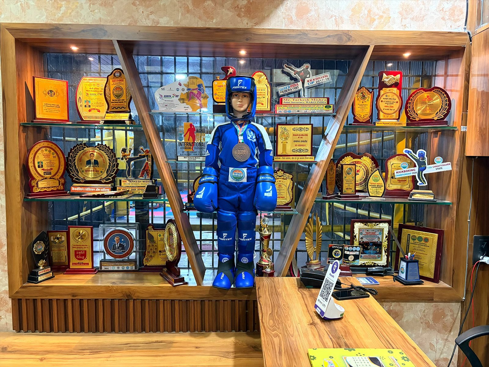 Trophy cabinet with awards and a kickboxing kit